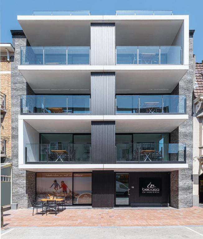 an external view of a building with a patio at Belcasa Mar Suites & Lofts Aparthotel in Middelkerke