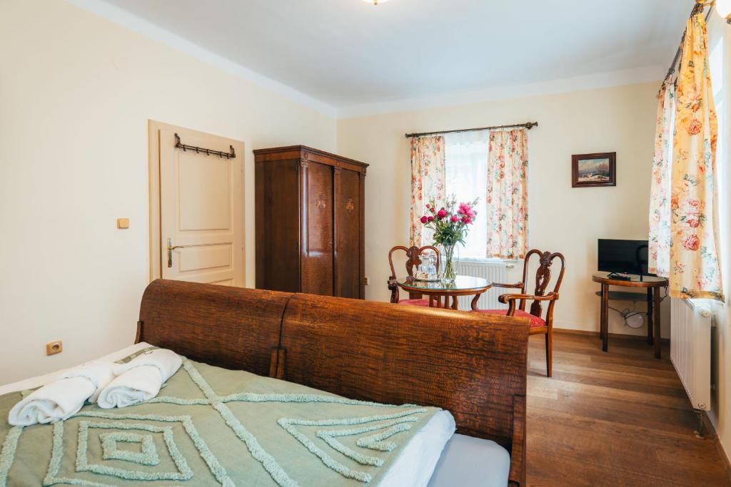a bedroom with a bed and a dining room with a table at Sv. Hubertus in Český Krumlov