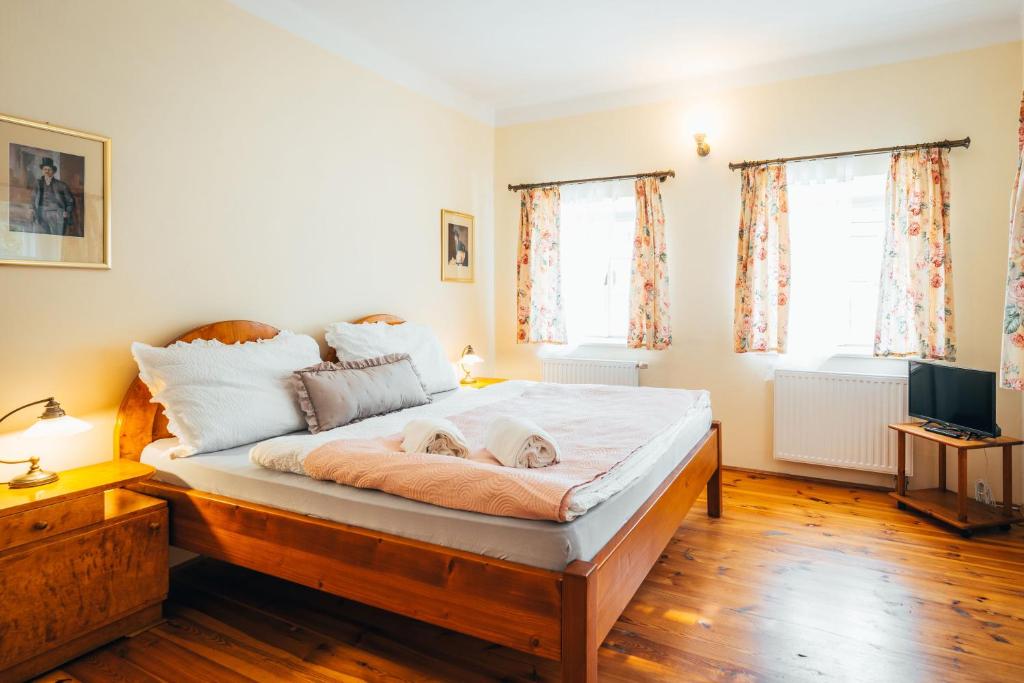 a bedroom with a bed with a dog laying on it at Sv. Hubertus in Český Krumlov
