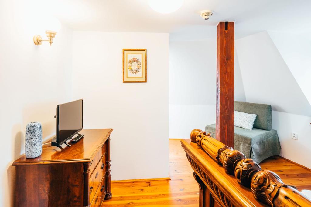 a living room with a television on a wooden table at Sv. Hubertus in Český Krumlov