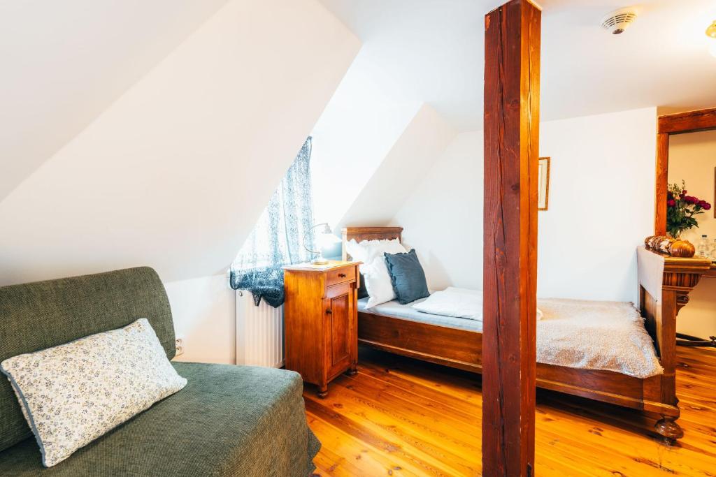 a bedroom with a bed and a mirror at Sv. Hubertus in Český Krumlov