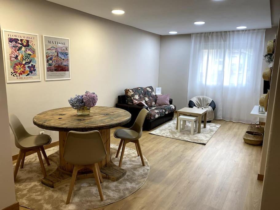 a living room with a table and a couch at Apartamento Solpor in Vilagarcia de Arousa