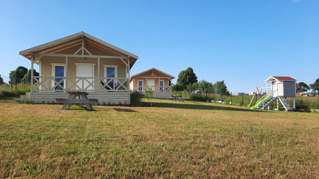 uma pequena casa no meio de um campo em Domki Wysokie Trawy Zdory em Pisz