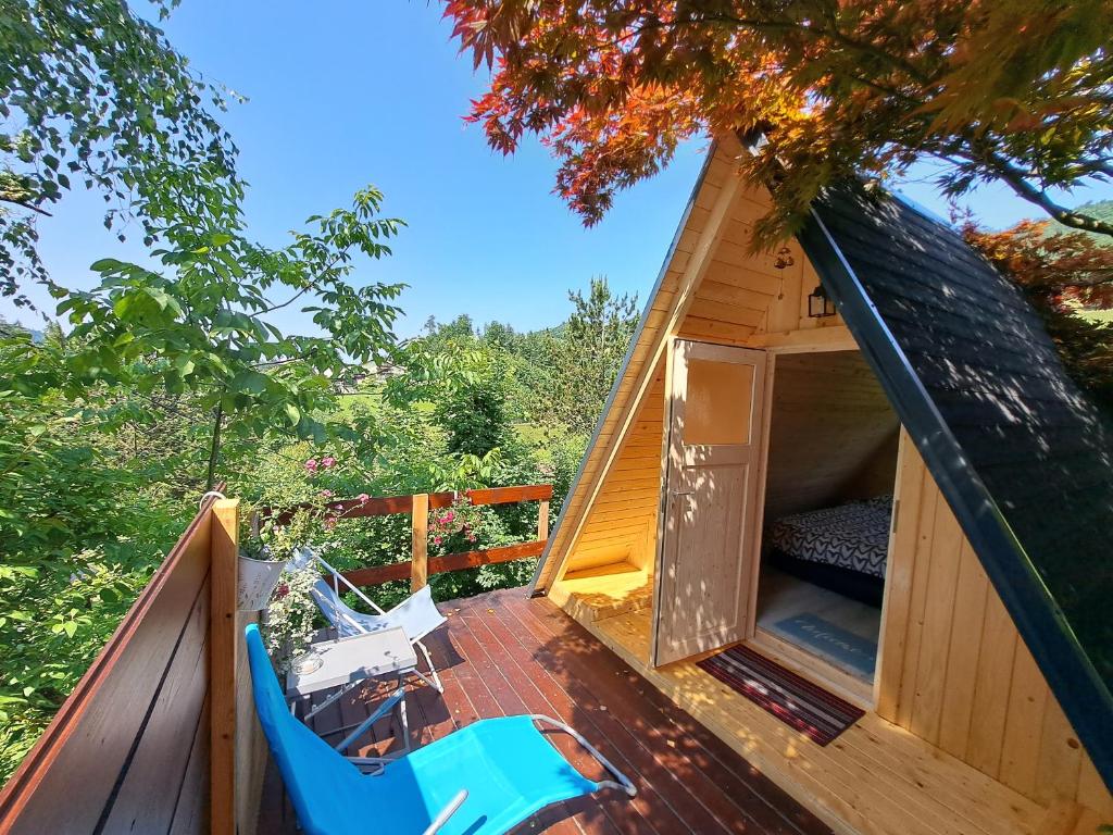 a gazebo with two chairs on a deck at Ozy's place in Kamnik