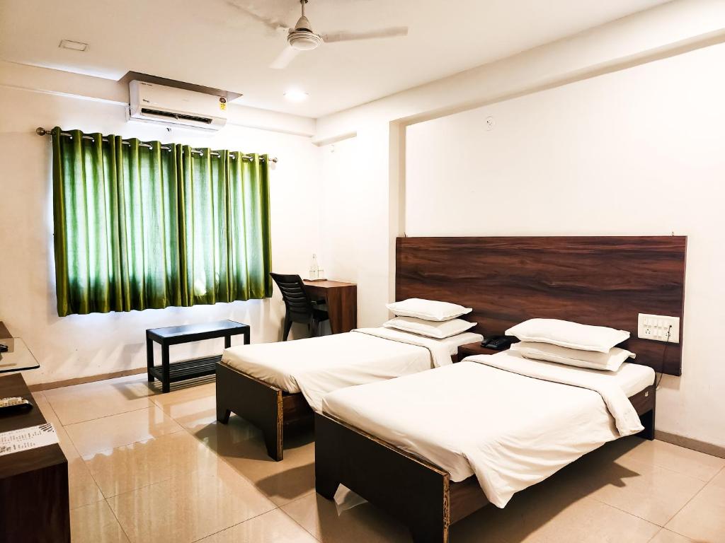 Postel nebo postele na pokoji v ubytování Hotel Rajwada Aurangabad