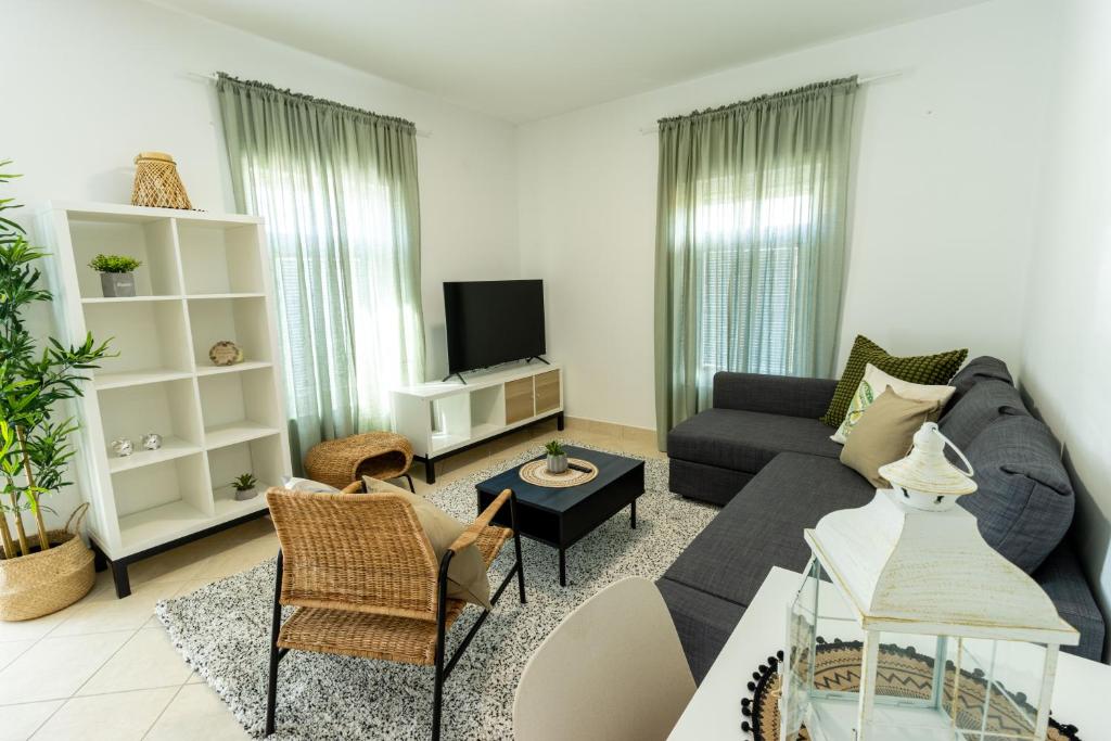 a living room with a couch and a tv at LUXURY STYLISH APARTMENT BURE in Murter