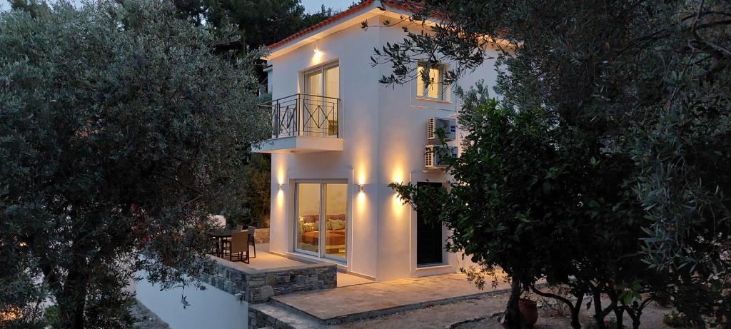 a large white house with a balcony on it at Les Maisonettes in Kokkari