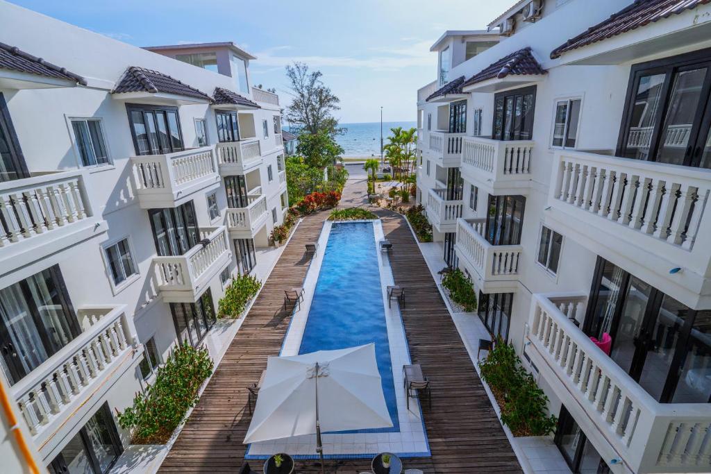 an overhead view of a pool between two buildings at Mary Beach Hotel & Resort in Sihanoukville