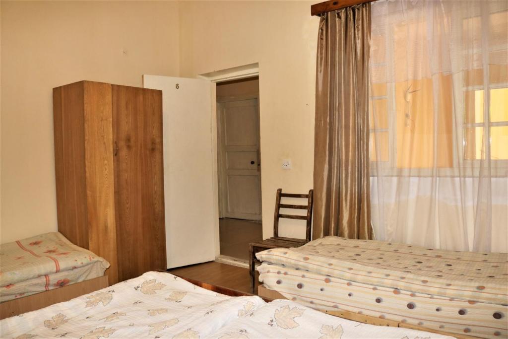 Postel nebo postele na pokoji v ubytování Taoskari Hotel