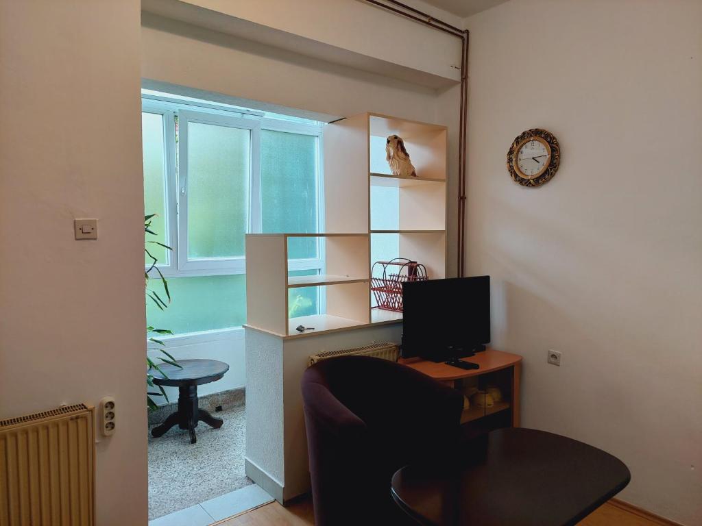 a room with a desk with a computer and a window at Apartman Ena in Sjenica