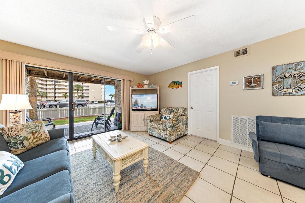 a living room with a couch and a table at Seaside Beach & Racquet 2105 in Orange Beach