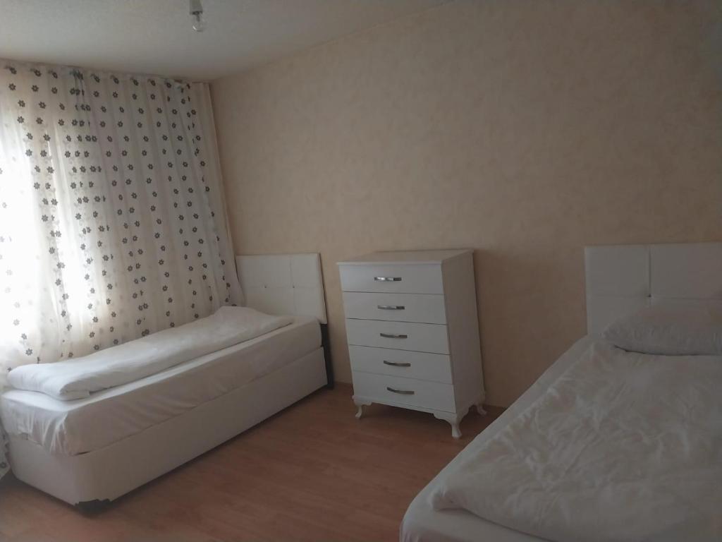 a bedroom with a bed and a dresser and a mattress at VİLLAGE GARDEN APART in Kemer