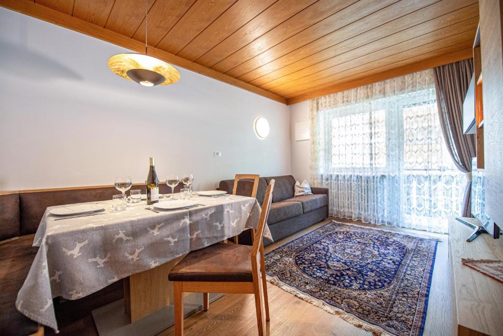 a dining room with a table and a couch at Apartment Brunelle in Selva di Val Gardena