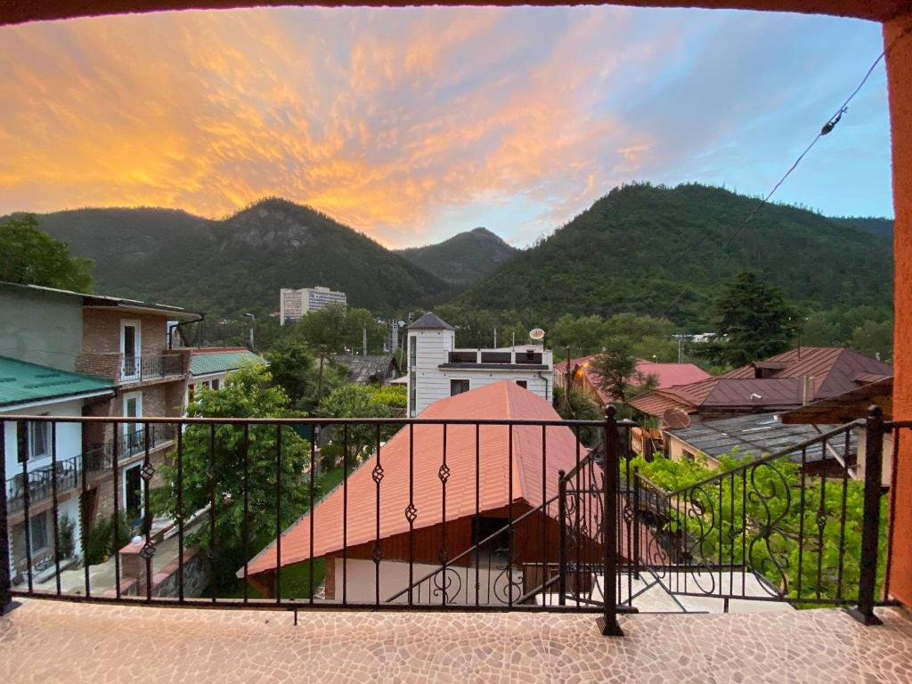 a balcony with a view of a city and mountains at Guest house BORJOMULA in Borjomi