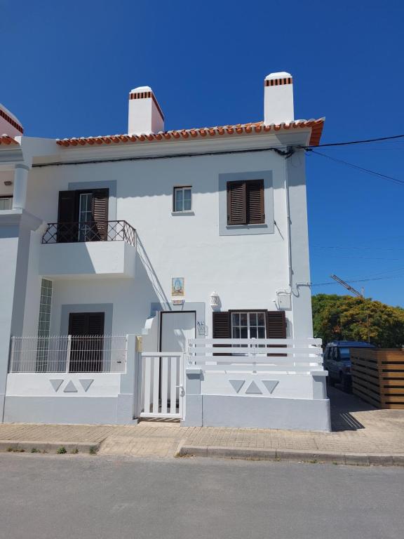 a white house with a staircase in front of it at Milfontes Beach House in Vila Nova de Milfontes