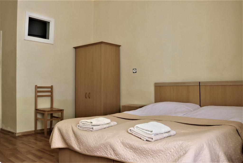 Postel nebo postele na pokoji v ubytování Taoskari Hotel