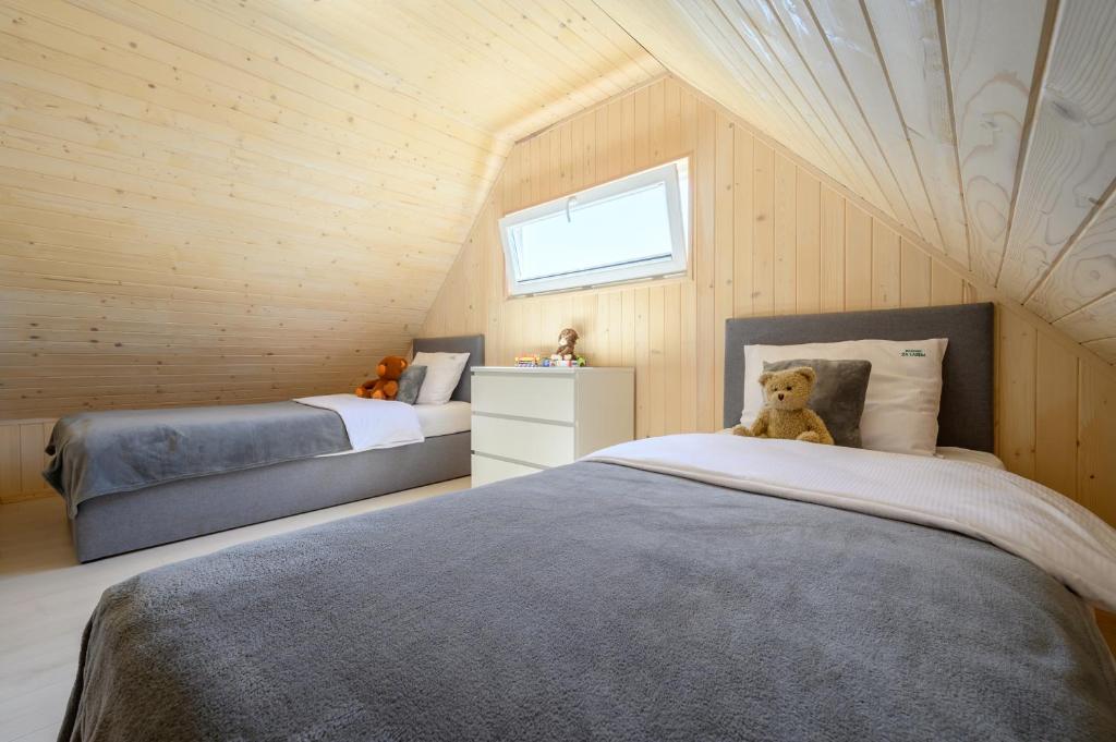 Postel nebo postele na pokoji v ubytování Resort Za Lasem