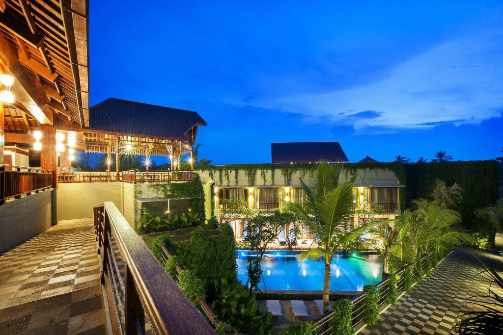 a resort with a swimming pool at night at Ubud Wana Resort in Ubud