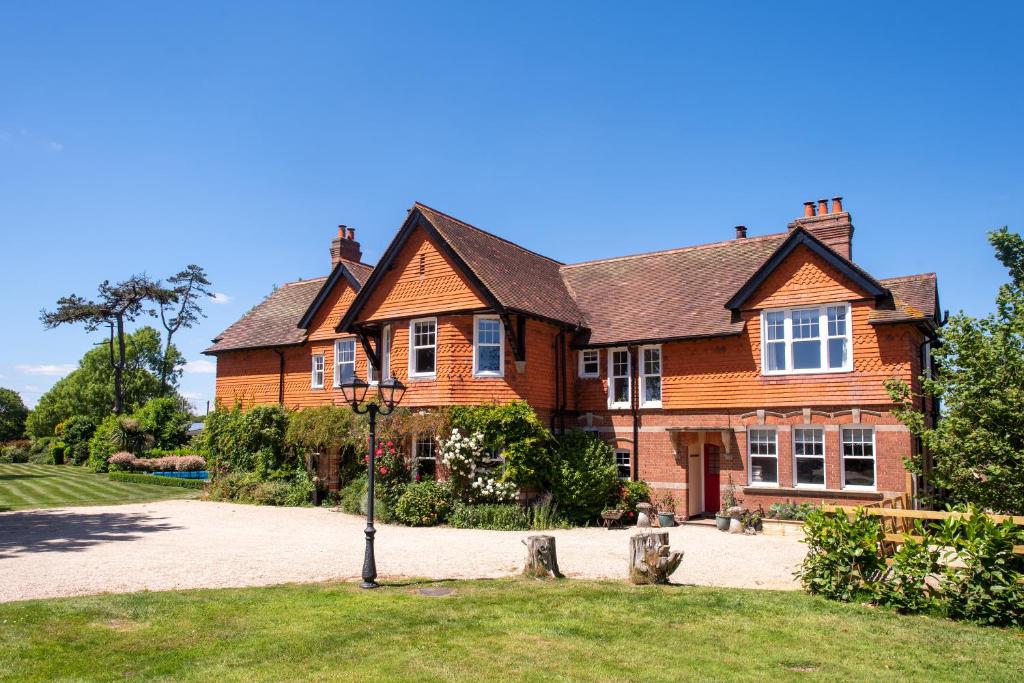 a large brown brick house with a driveway at Dower House Hotel in Lyme Regis