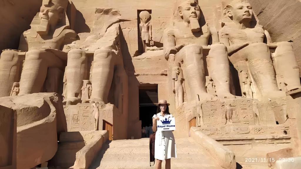 a woman standing in front of thearaohs at Royal Home Luxor Nile View in Luxor
