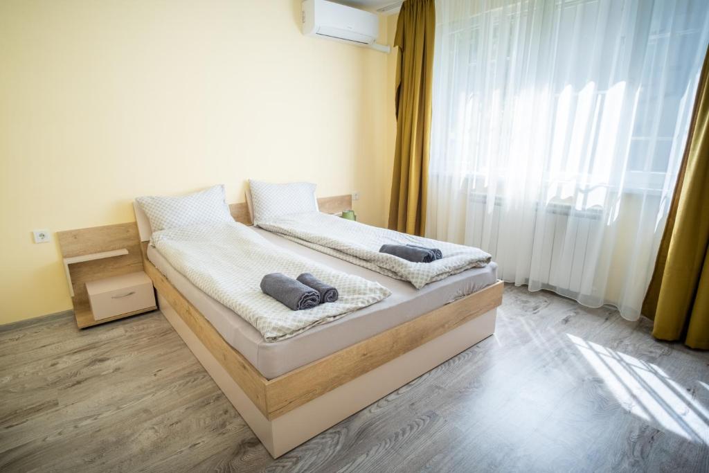 a bedroom with a bed with two towels on it at Apartment Yana in Ruse