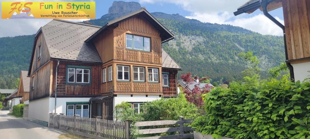a wooden house with a mountain in the background at Klampfner Gütl by FiS - Fun in Styria in Altaussee