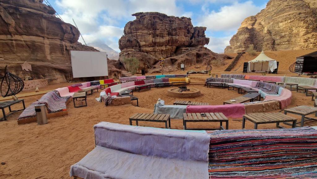 a group of tables and chairs in the desert at Aladdin Camp in Wadi Rum