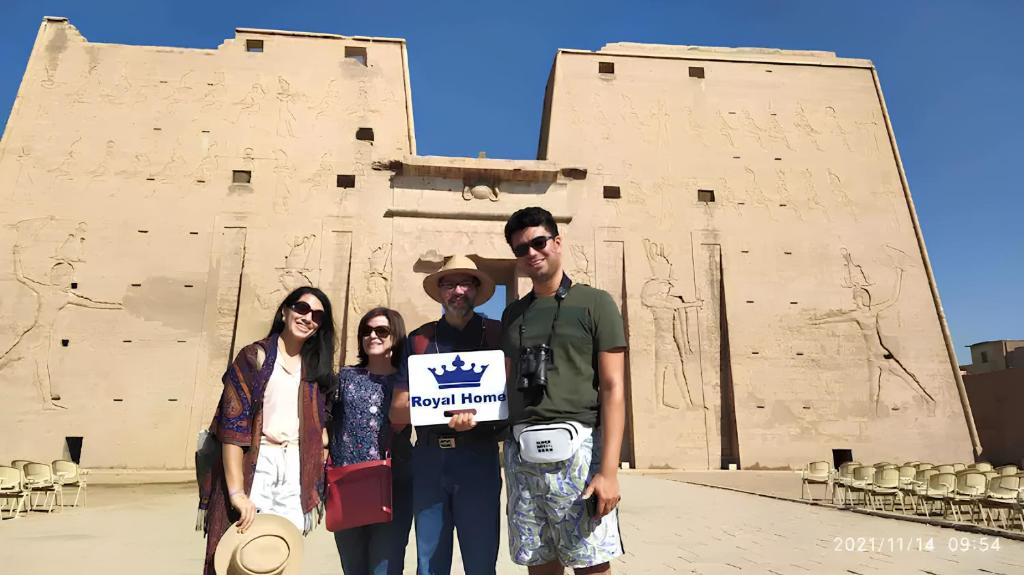 a group of people holding a sign in front of a building at Royal Home Luxor Nile View in Luxor