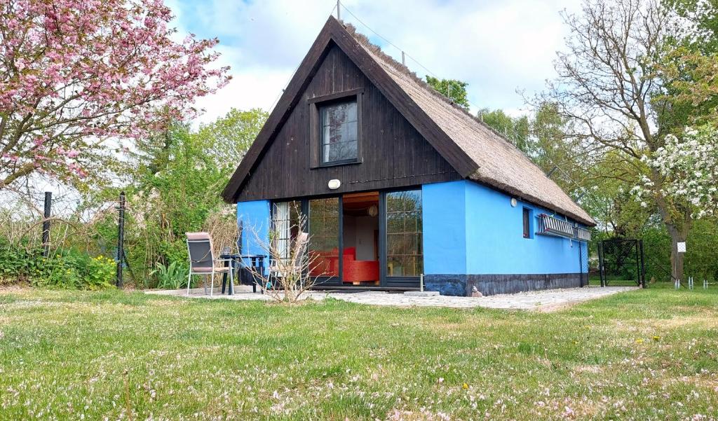 una casa azul con techo de gambrel en Blaues Haus by Rujana, en Zirkow