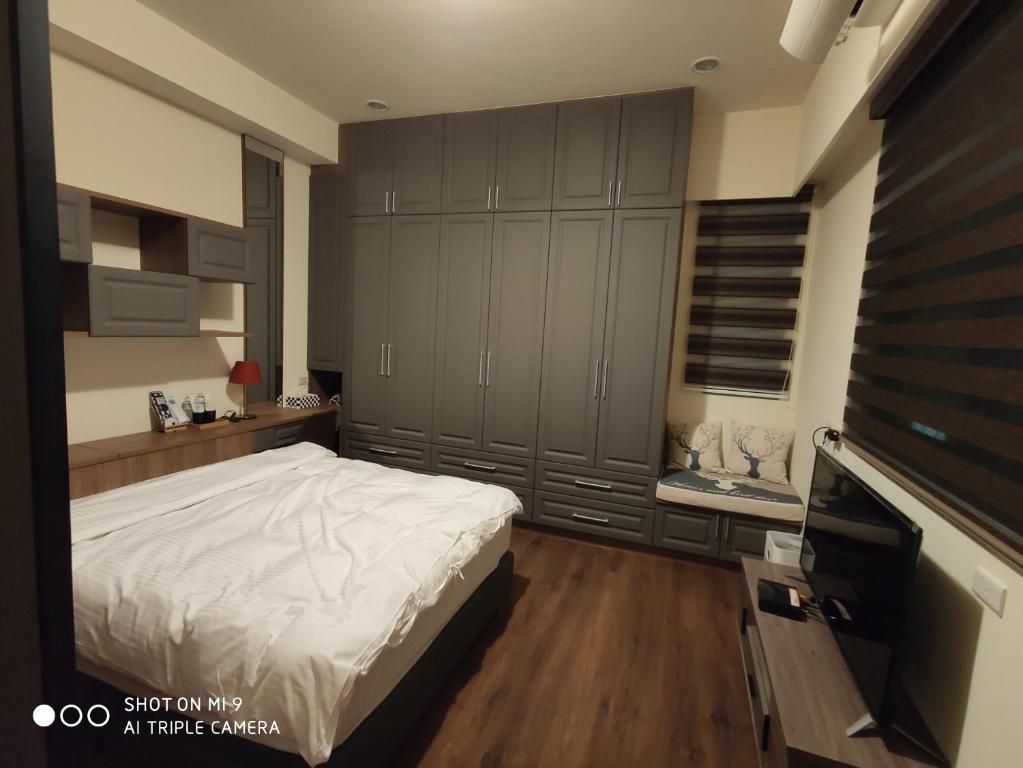 Postel nebo postele na pokoji v ubytování WT BnB Taichung