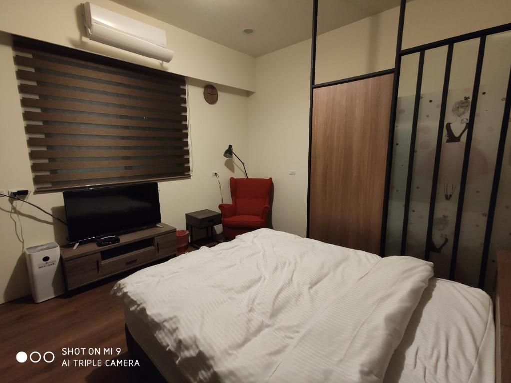 Postel nebo postele na pokoji v ubytování WT BnB Taichung