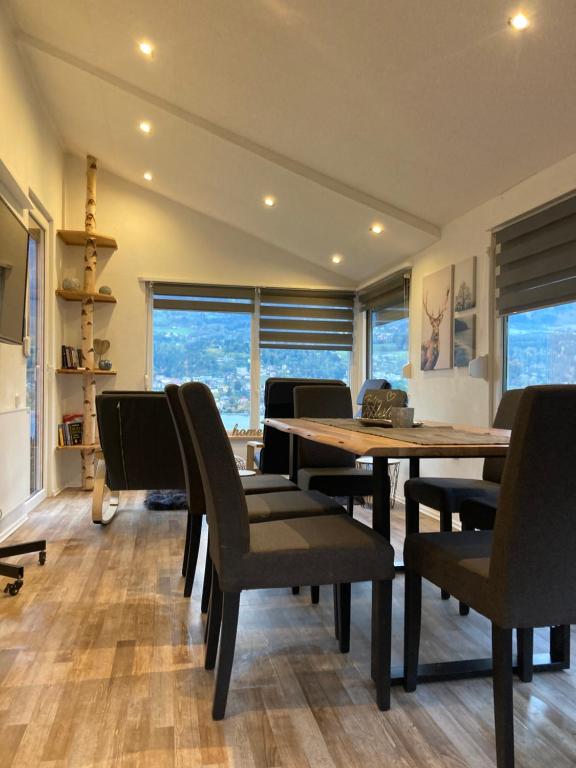 a dining room with a wooden table and chairs at Familienchalets am Millstätter See in Rothenthurn