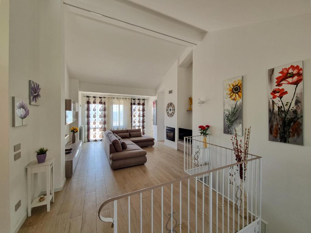 sala de estar con escalera y sofá en Villa Rosa, en Latronico