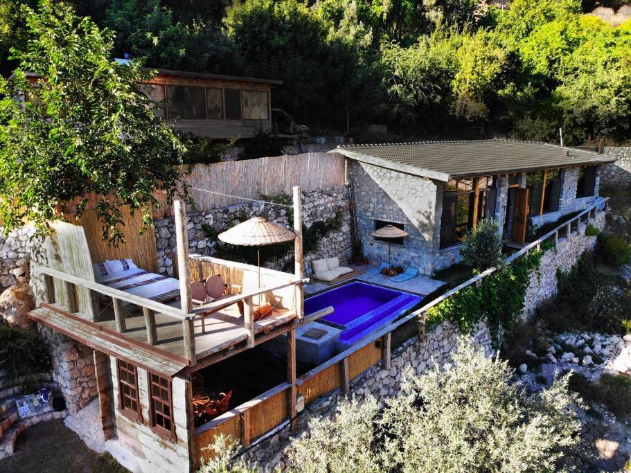 an aerial view of a house with a swimming pool at 19th Century Neo-Modern KABAK VALLEY STONE HOUSE in Fethiye