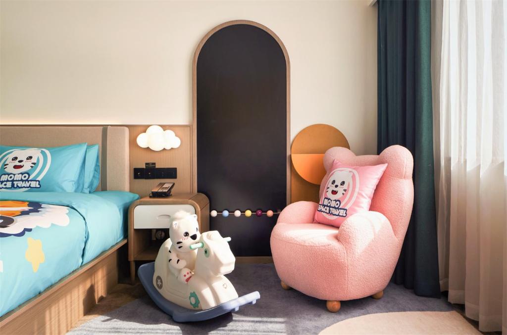 Postel nebo postele na pokoji v ubytování Wanda Yi Hotel Wuxi