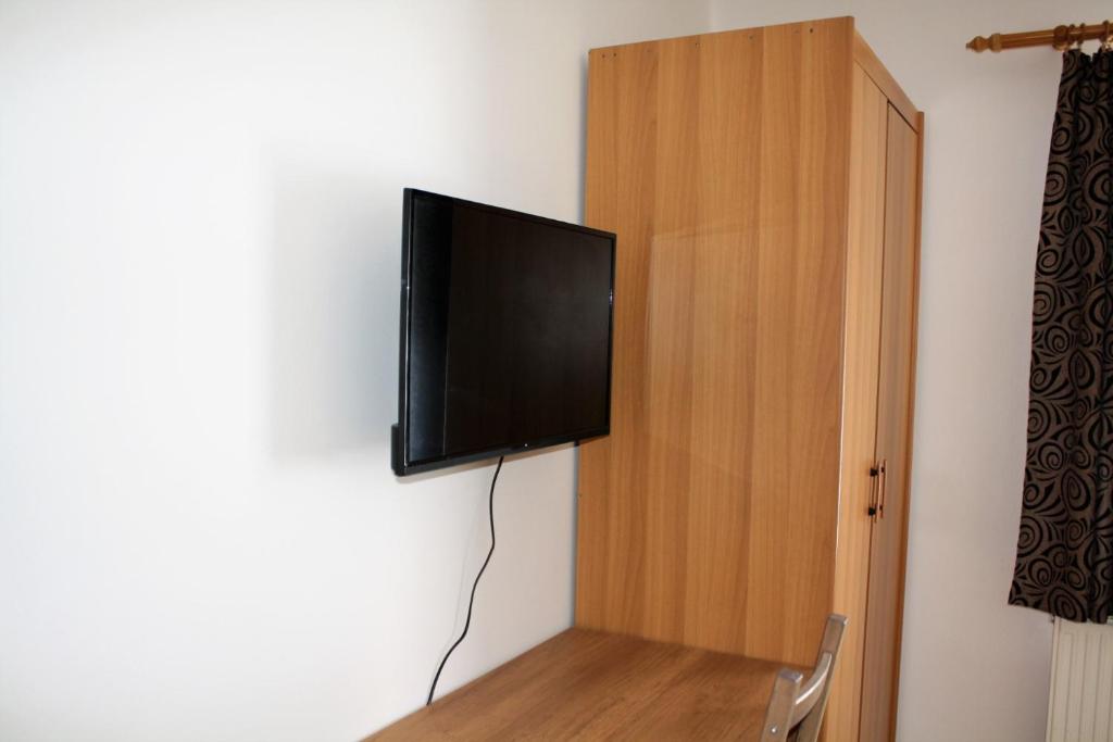 TV a/nebo společenská místnost v ubytování Rembrandt Vendégház