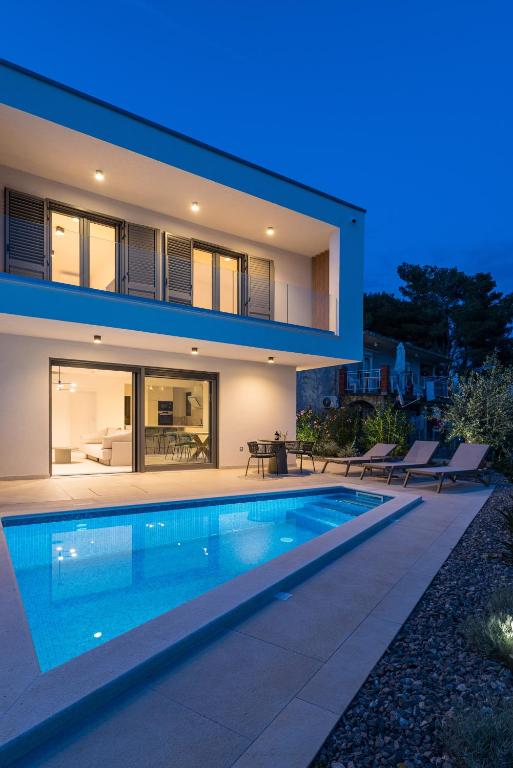 a house with a swimming pool at night at Villa Cvita east in Primošten