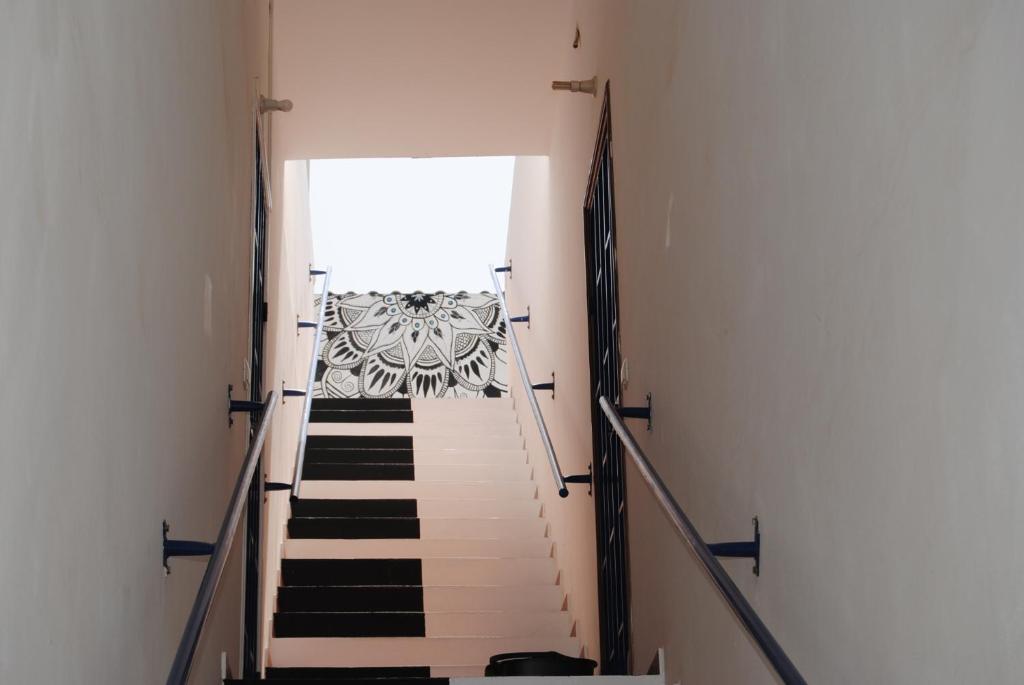 a staircase in a building with black and white stairs at A.M.A Appartament in Calheta Do Maio