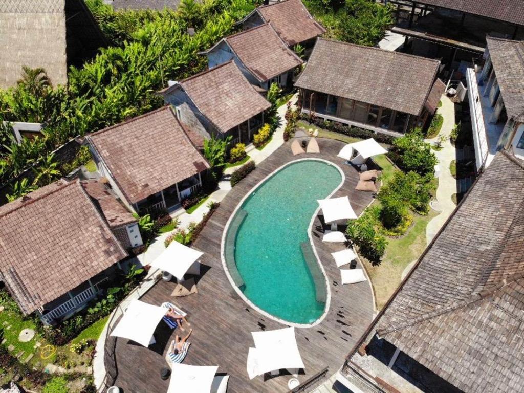 an aerial view of a resort with a swimming pool at Spaces Bali Unique Boutique Hotel in Munggu