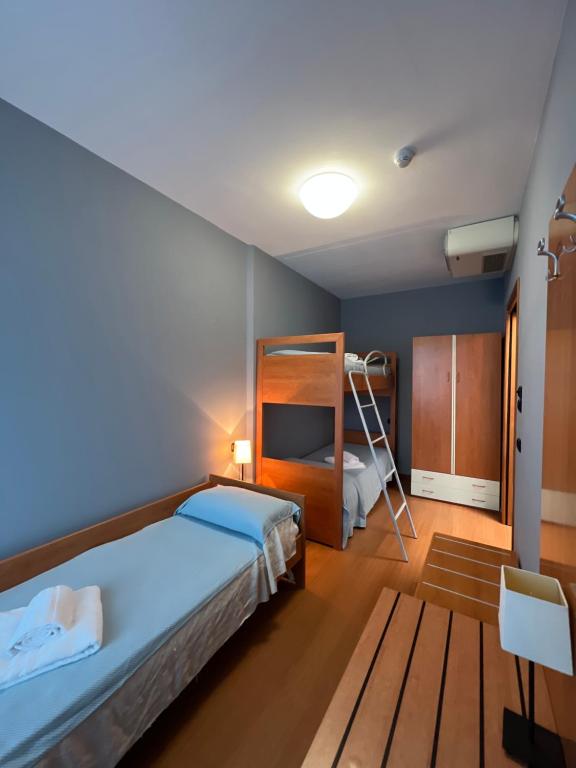 A bed or beds in a room at Hotel Alemagna Bed&Breakfast Bibione Lido del Sole