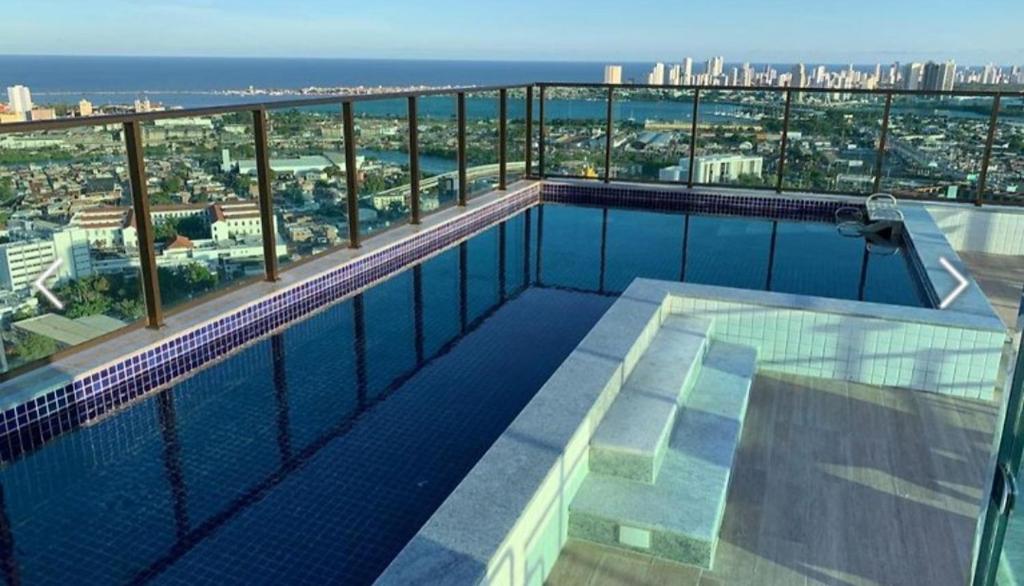 a swimming pool on the top of a building at Flat Lindo e Aconchegante in Recife