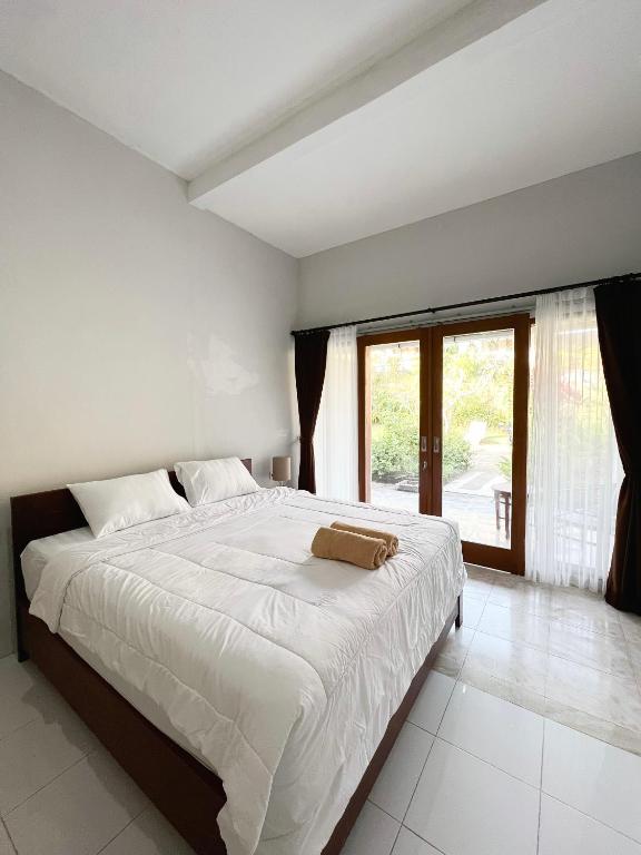 Postel nebo postele na pokoji v ubytování D'pandawa guest house