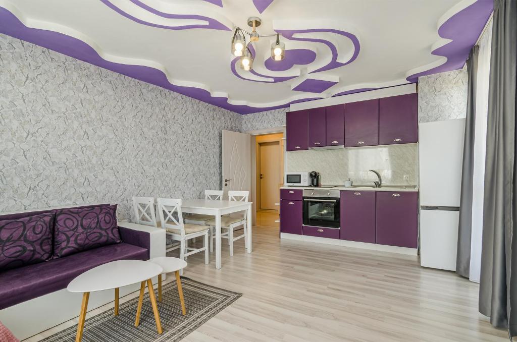 a living room with a purple couch and a table at Buddy in Varna City