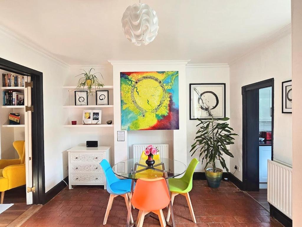 a dining room with a glass table and chairs at No.2 Boutique Art Townhouse  in Lincolnshire