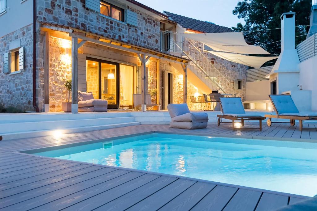 a swimming pool in the backyard of a house at Dolce Terra in Stari Grad