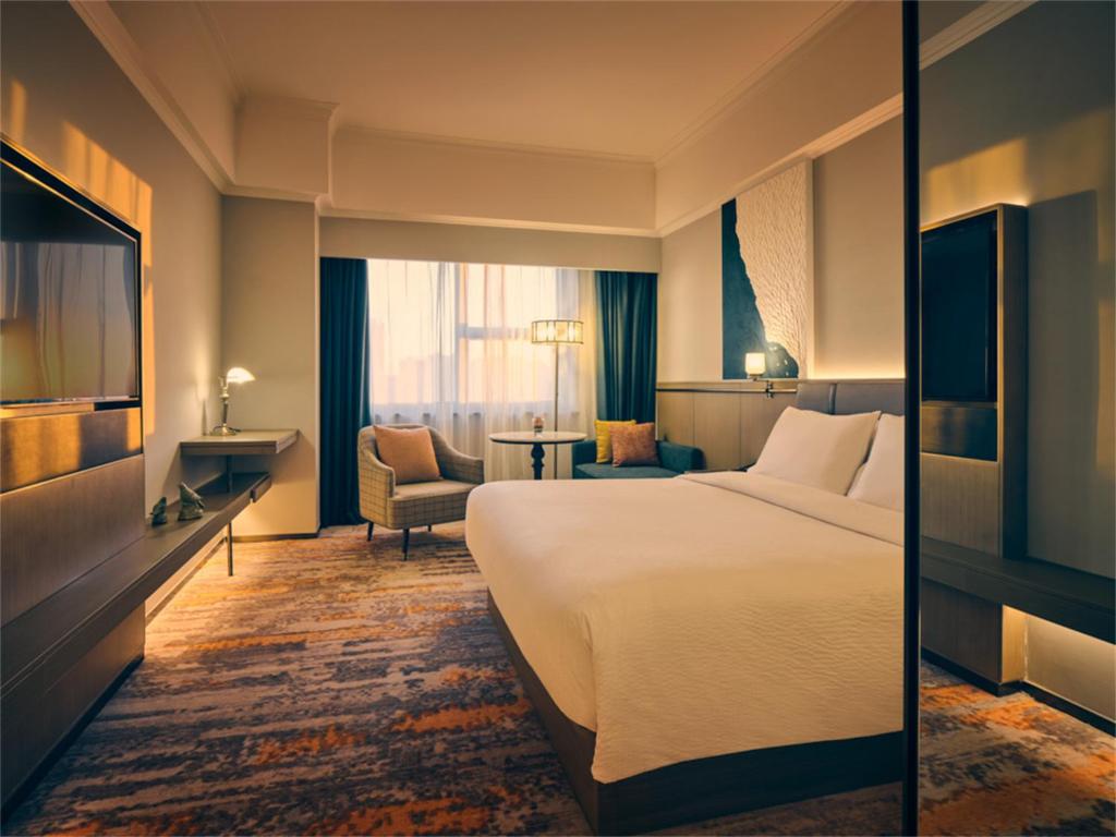 Postel nebo postele na pokoji v ubytování Wanda Yi Hotel Wuxi