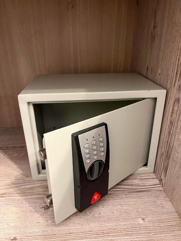 a microwave oven with a remote control in it at Alexandros Hotel Apartments in Vourvourou