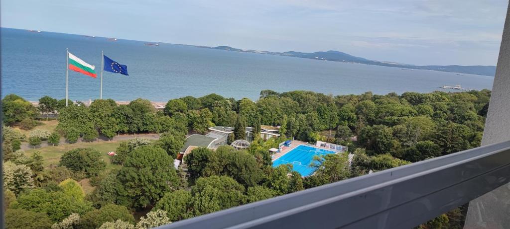 a view of a resort with a pool and a flag at SEA VIEW FLORA in Burgas
