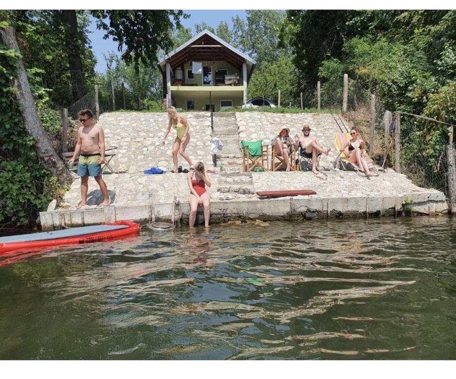 a group of people playing in the water at green house at silver lake in Ostrovo