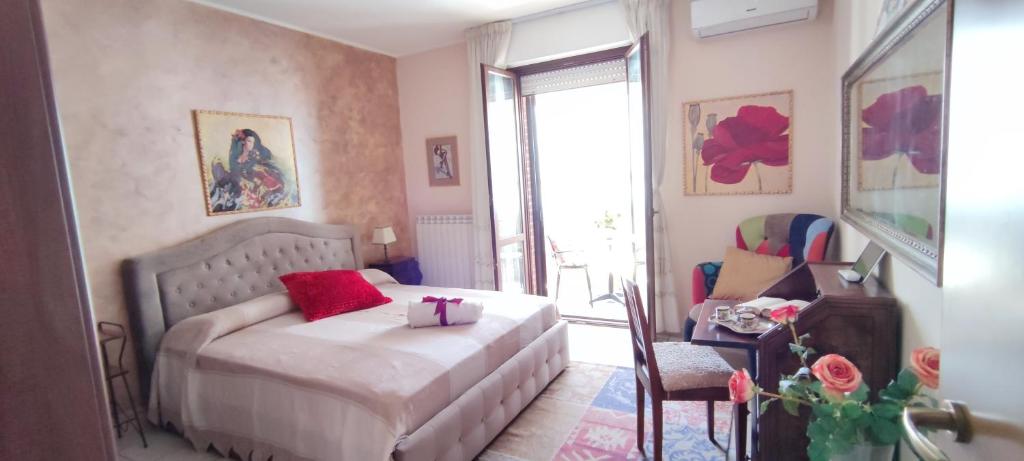 a bedroom with a bed with a red pillow on it at A casa di Ilde in Silvi Marina
